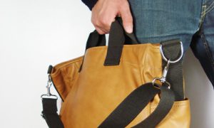 a person holding a brown bag